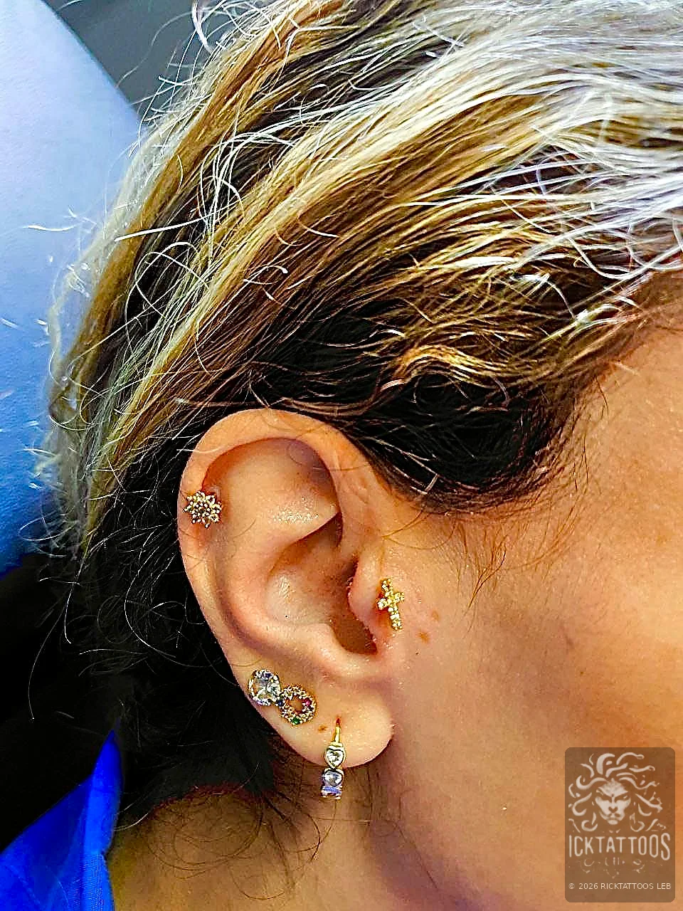 Professional gold ear piercing by RickTattoos Beirut